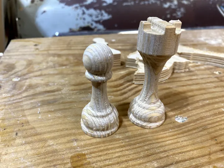 A pawn and a rook, carved and cut free