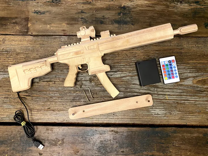 The wooden rifle replica with its LED strip and remote