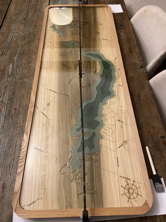 A long lake-map table with resin water